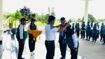 Bupati Haltim saat mengalungkan tanda peserta POPDA